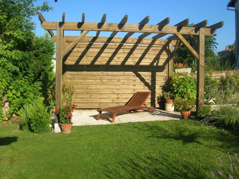 pergola ajourée en bois avec un pan de mur plein