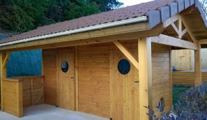 pool house fermé en bois avec des portes à hublot